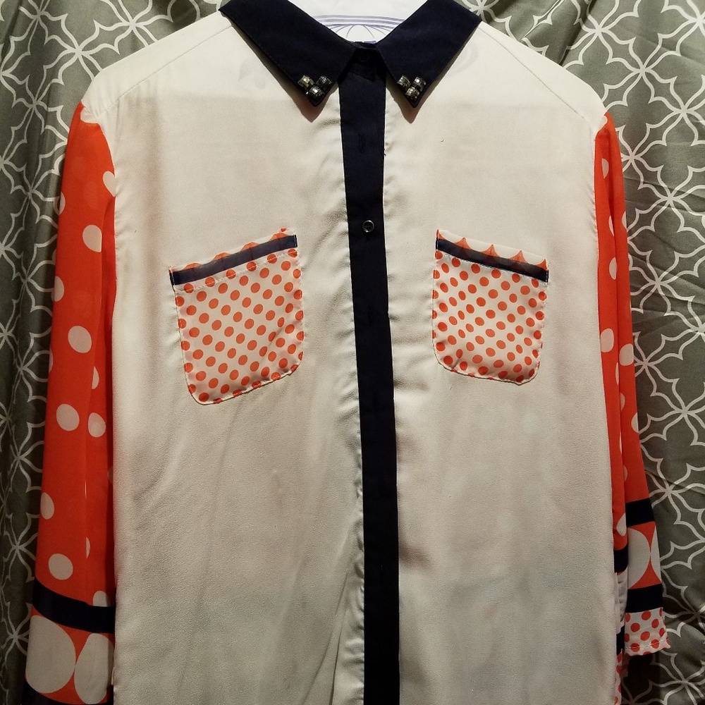 White, orange/red and navy blouse